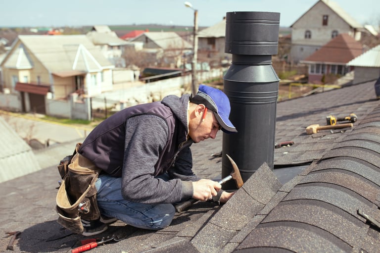 Professional roofer repairing roof